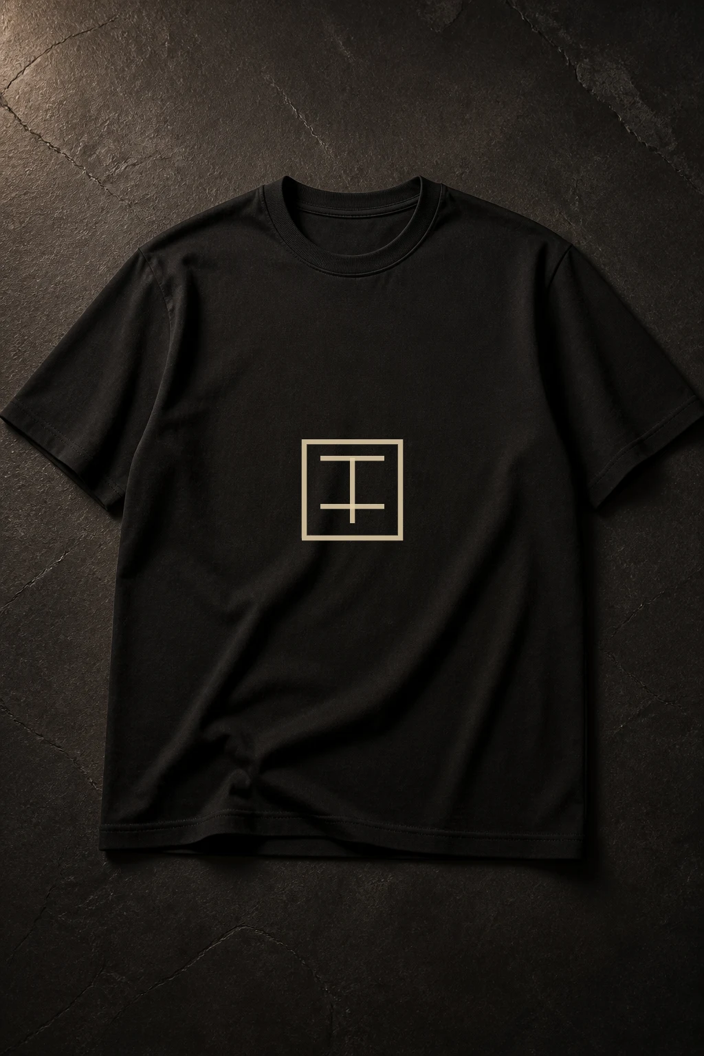 EU Archive Line Tee photographed as a premium dark editorial still with the archive mark centered on the chest.